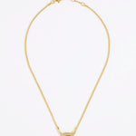 Gold necklace with a square tigers eye stone surrounded by small crystals on a gold chain and white background