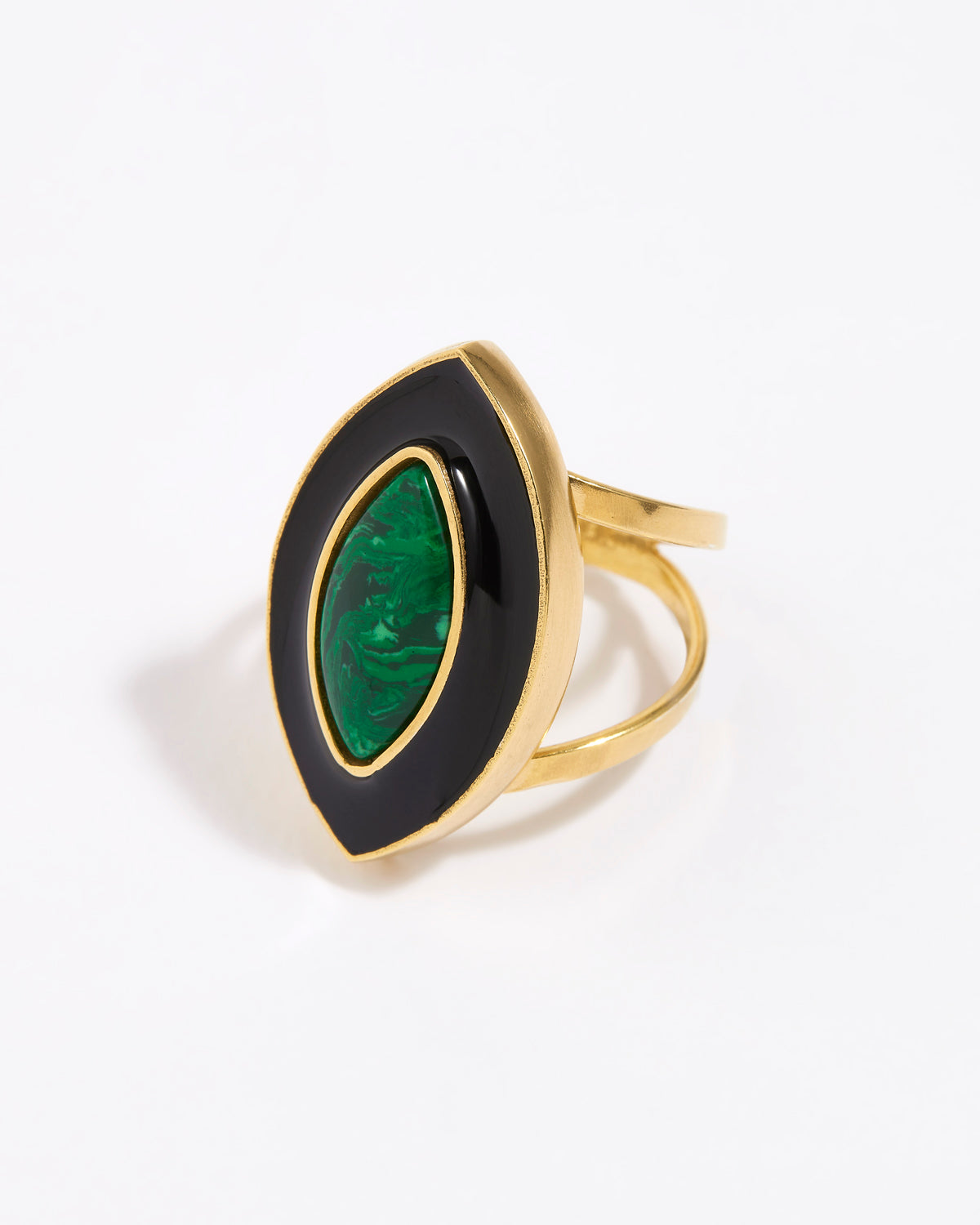 Gold ring with a green malachite gemstone and black enamel surround on a white background