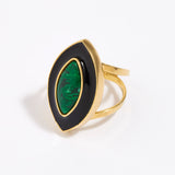 Gold ring with a green malachite gemstone and black enamel surround on a white background