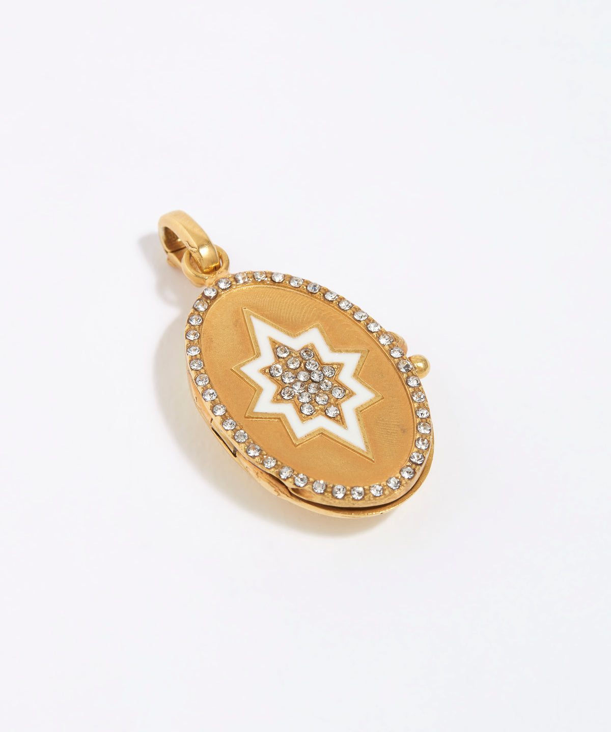 Oval Gold pendant with white start and cystals to centre of star and around the edge, on a white background