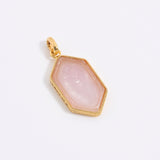Pink murano glass pendant with gold frame on a white background