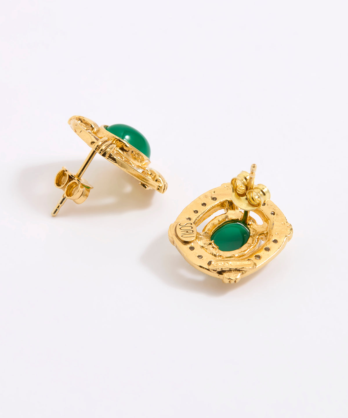 A reverse and side image of a pair of gold earrings with oval green cabochon stones, shown on a white background.