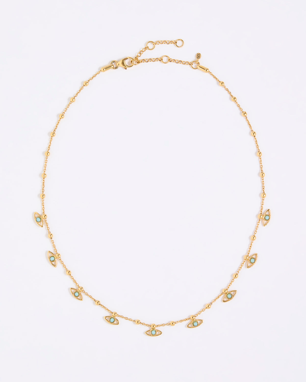 Gold necklace with small eye-shaped charms on a light gray background