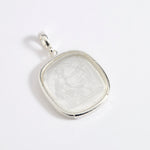 Silver and near clear glass pendant depicting Diana, Goddess of the Hunt. 