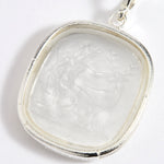 Close up of silver charm with embossed goddess Diana