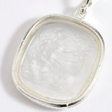 Close up of silver charm with embossed goddess Diana