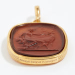Gold pendant with a brown stone featuring an engraved design "always believe in yourself" on a white background.