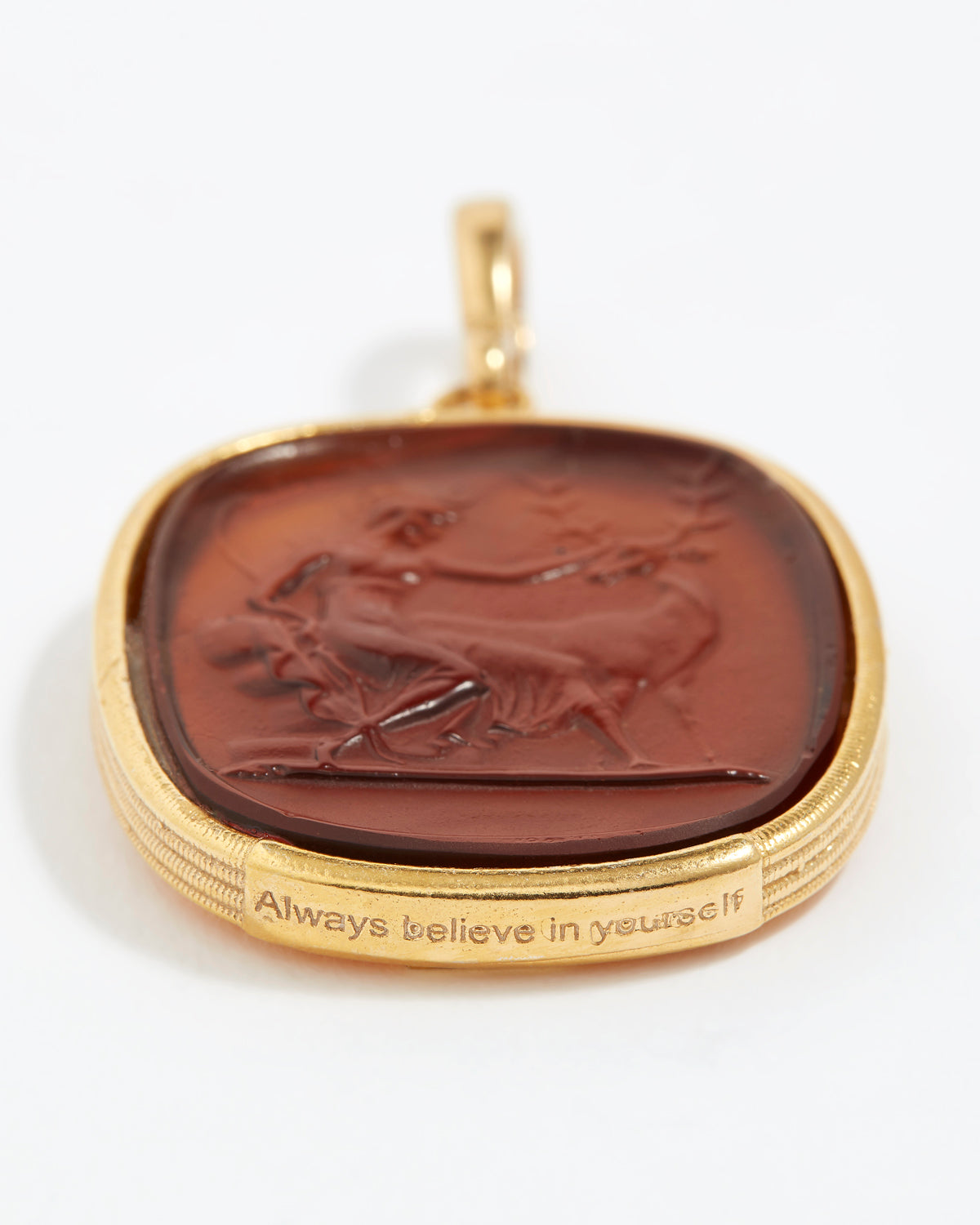 Gold pendant with a brown stone featuring an engraved design "always believe in yourself" on a white background.