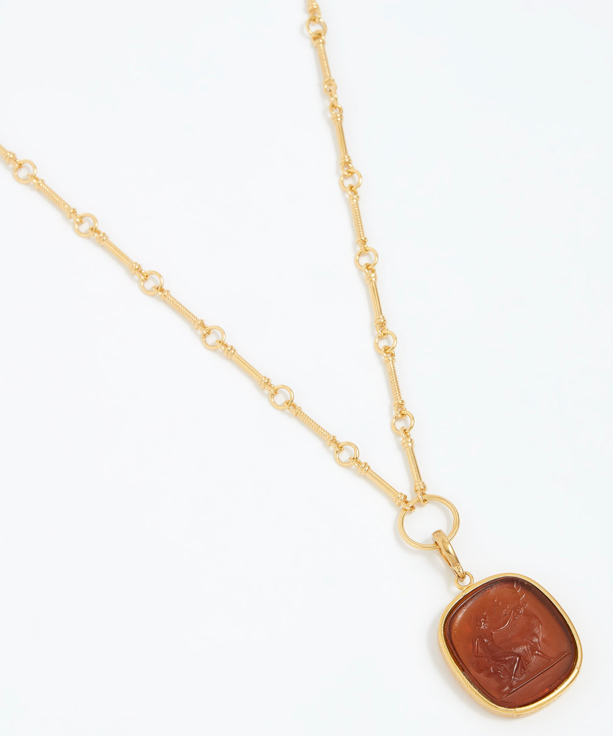 Gold necklace with a brown pendant on a white background