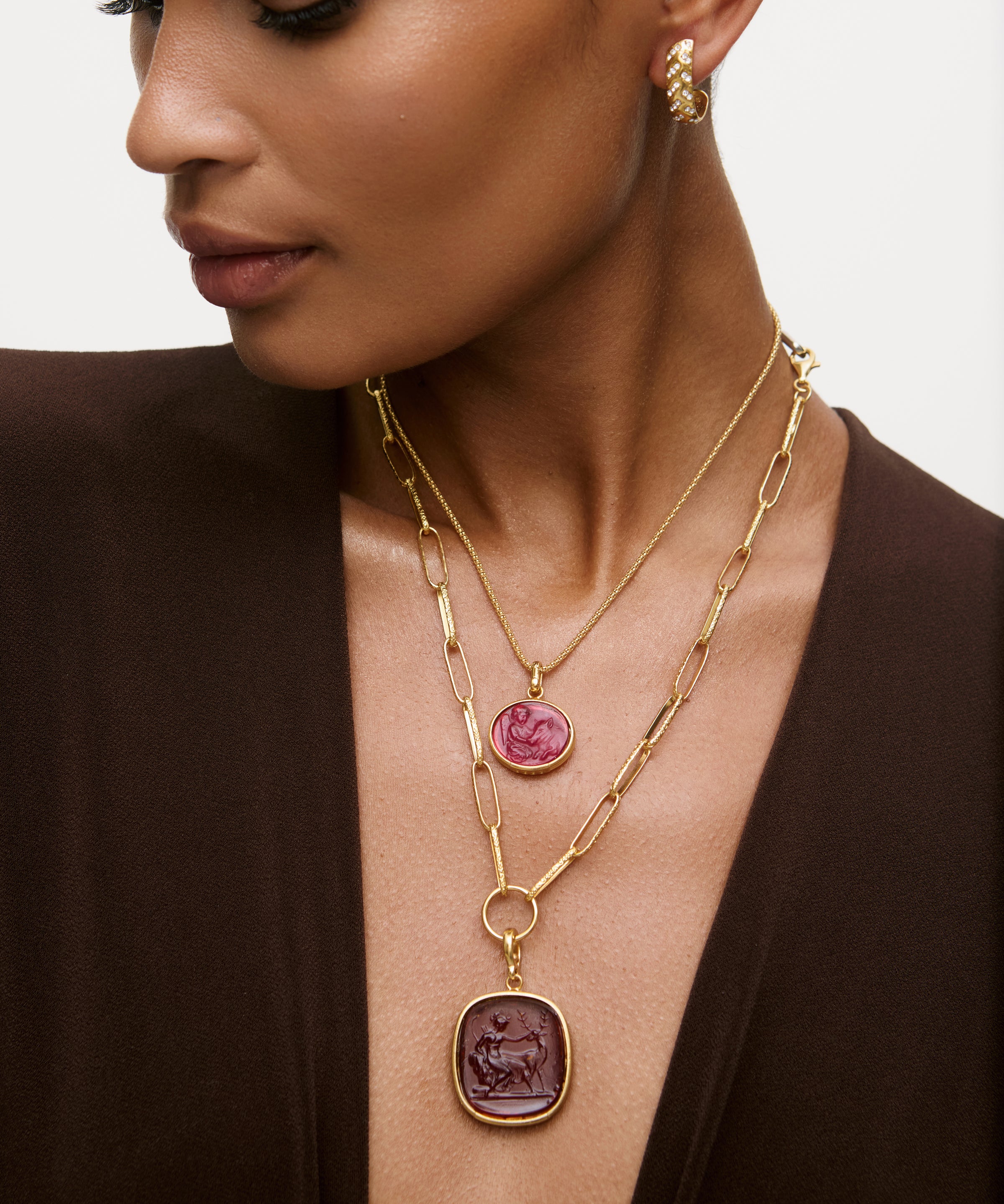 Two layered murano glass pendant necklaces worn on model with neutral background 