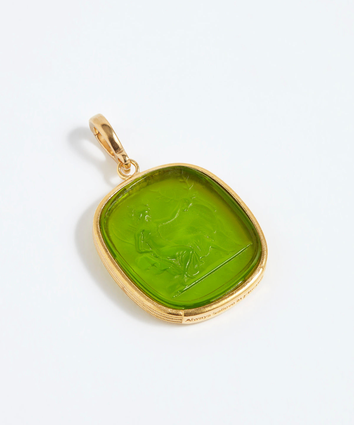 Gold pendant with a green stone on a white background
