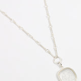 Large silver and near clear glass charm on silver link style necklace 