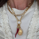Image of soru charm chain with madonna pendant and red cornucopia pendant charm  and soru scomo necklace around a neck