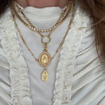 Im age of necklace set on a neck- the madonna ncklace and pelllegrino charm on a charm chain with the como necklace 