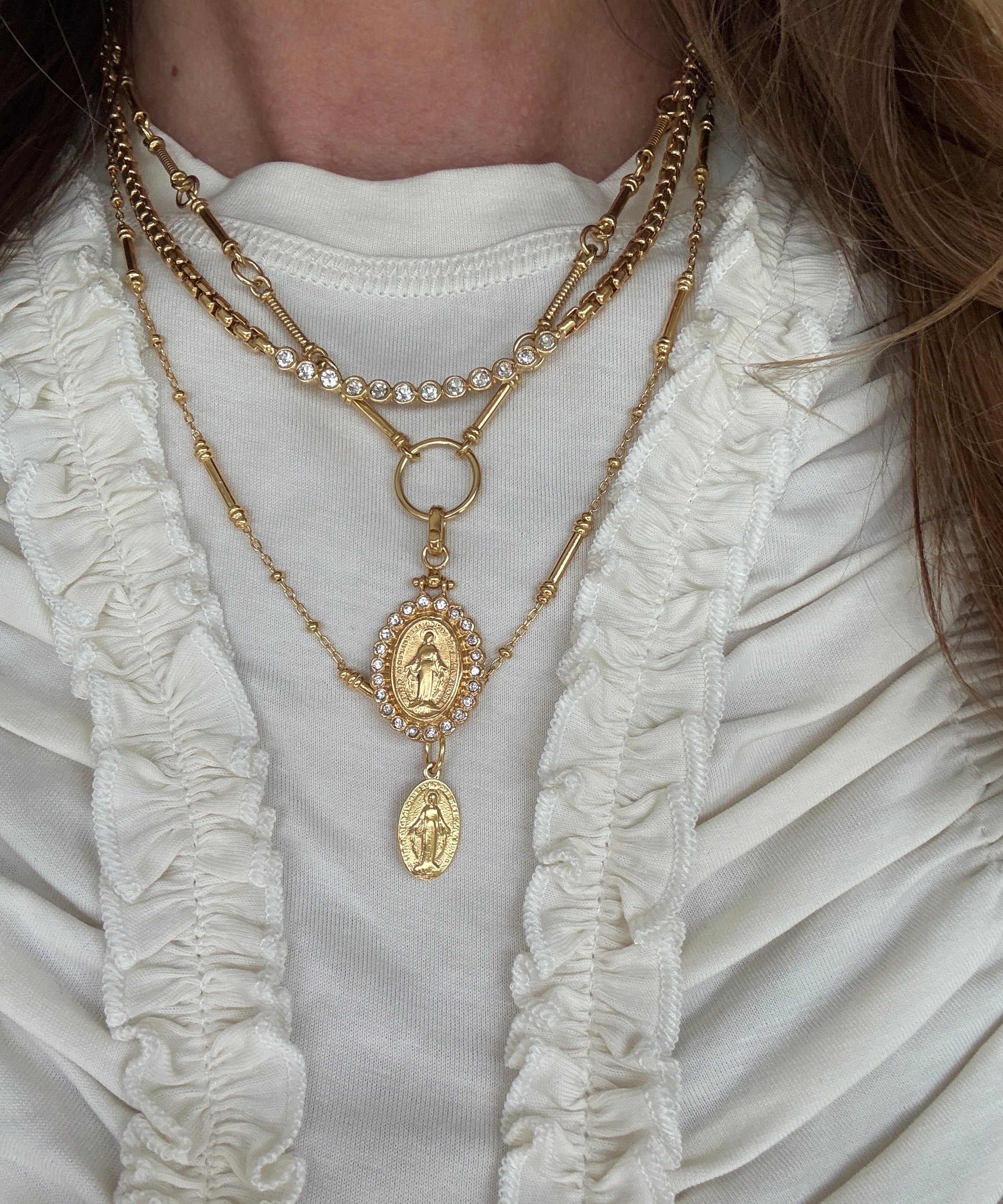 Im age of necklace set on a neck- the madonna ncklace and pelllegrino charm on a charm chain with the como necklace 