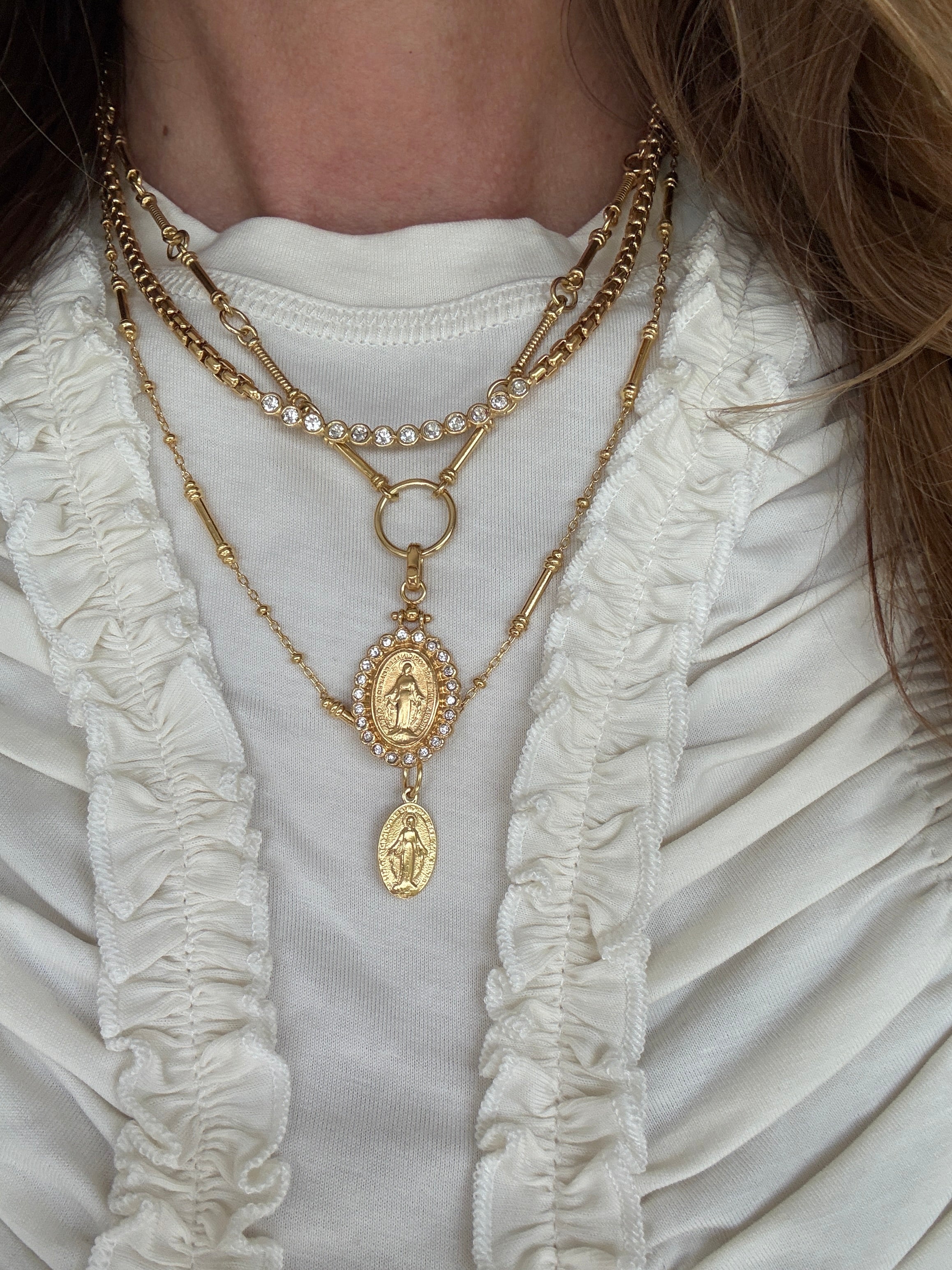 Im age of necklace set on a neck- the madonna ncklace and pelllegrino charm on a charm chain with the como necklace 