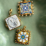 imgae of 3 square tile charms in a green ceramic tray- 2 tiles have colourful majolica and one is a sun and a moon in white ceramics