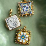 imgae of 3 square tile charms in a green ceramic tray- 2 tiles have colourful majolica and one is a sun and a moon in white ceramics
