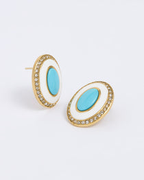 Product shot of a oval earrings combine glossy turquoise and white enamel with a halo of sparkling crystals on a white background.