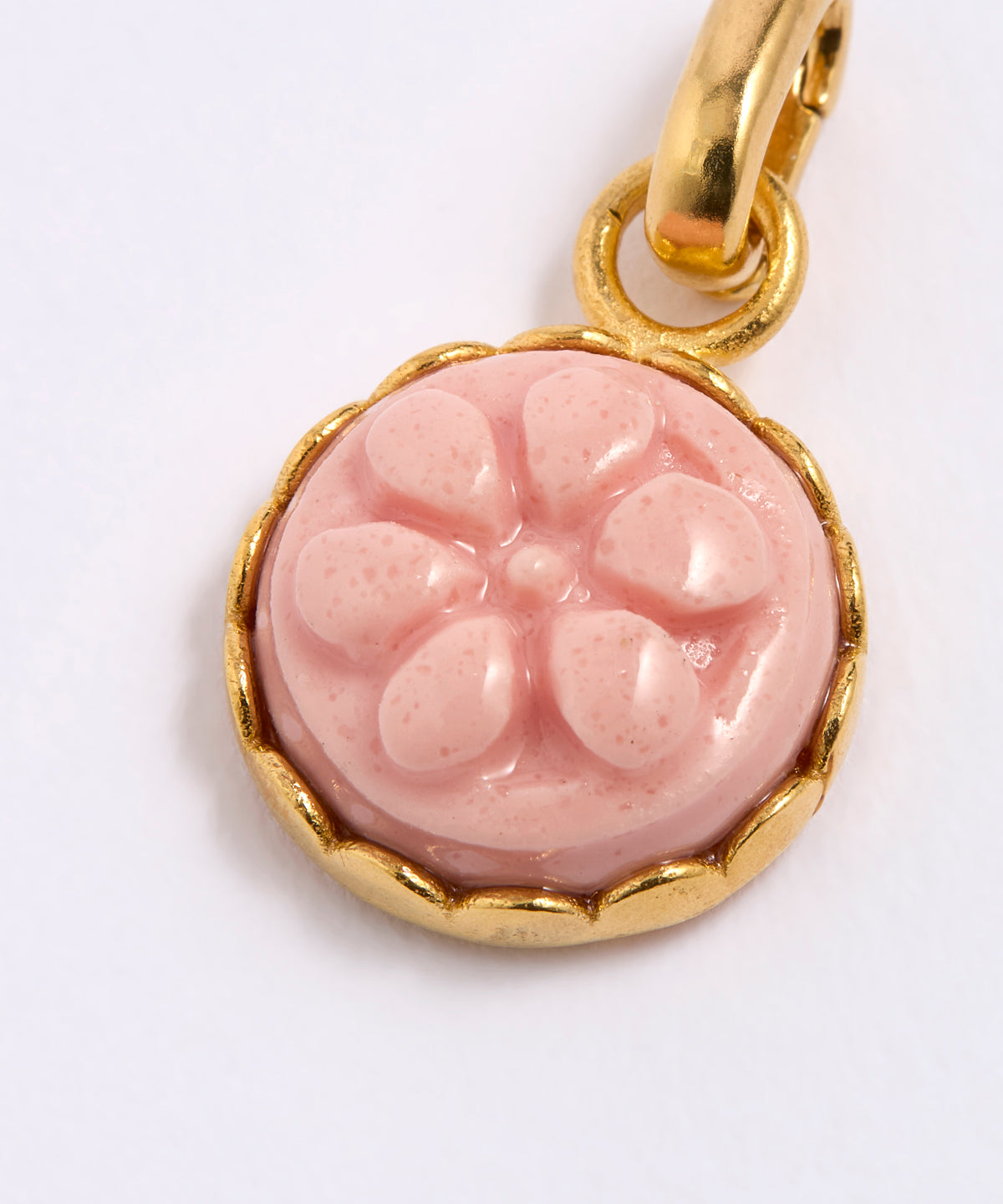 Pink floral pendant with gold frame on a white background