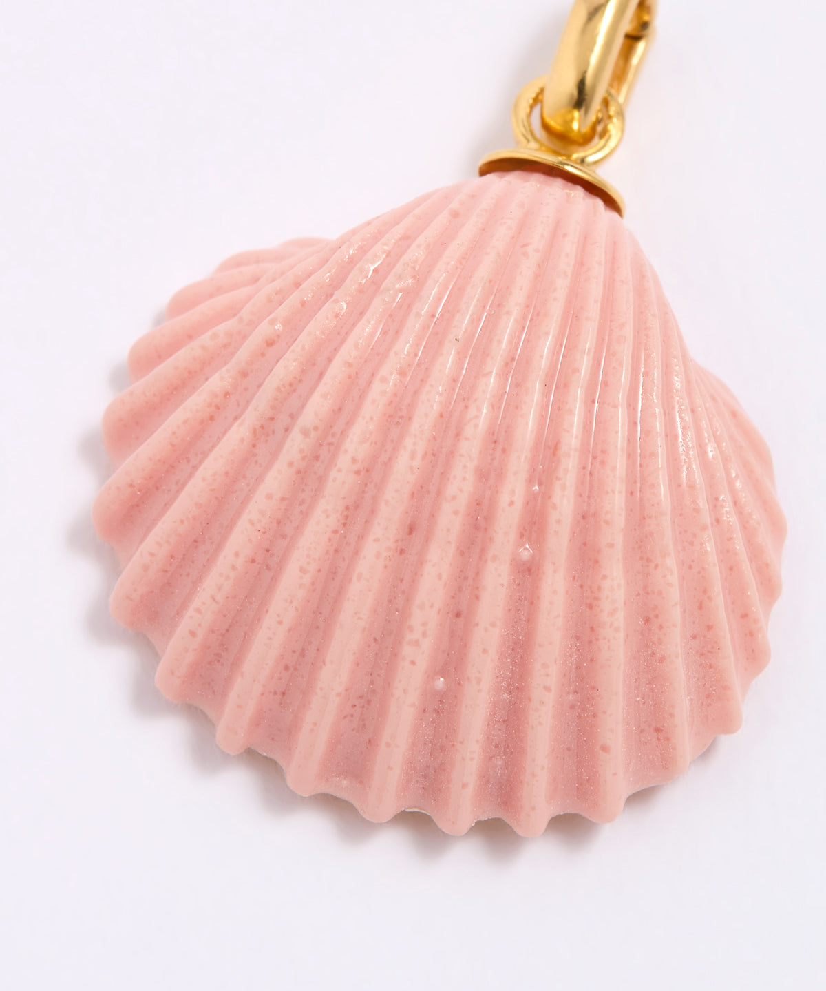 Pink shell pendant with gold accent on a white background