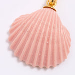 Pink shell pendant with gold accent on a white background