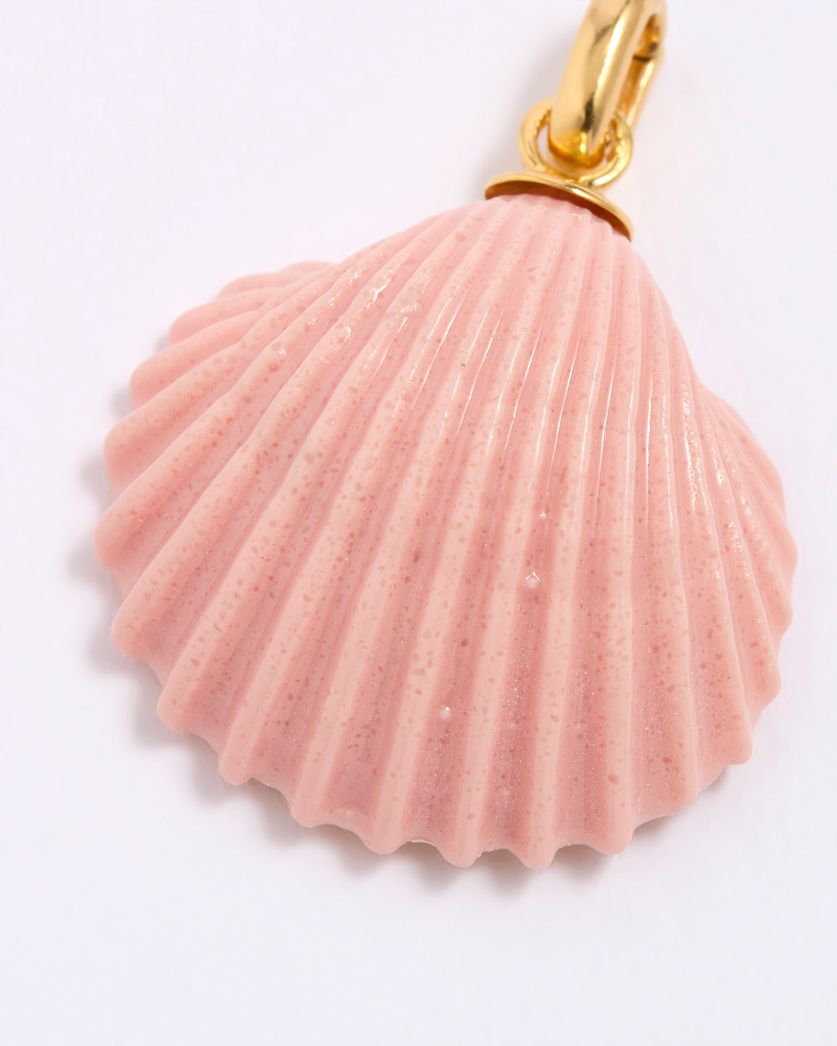Pink shell pendant with gold accent on a white background