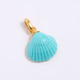 Turquoise shell pendant with gold coloured clasp on a light gray background