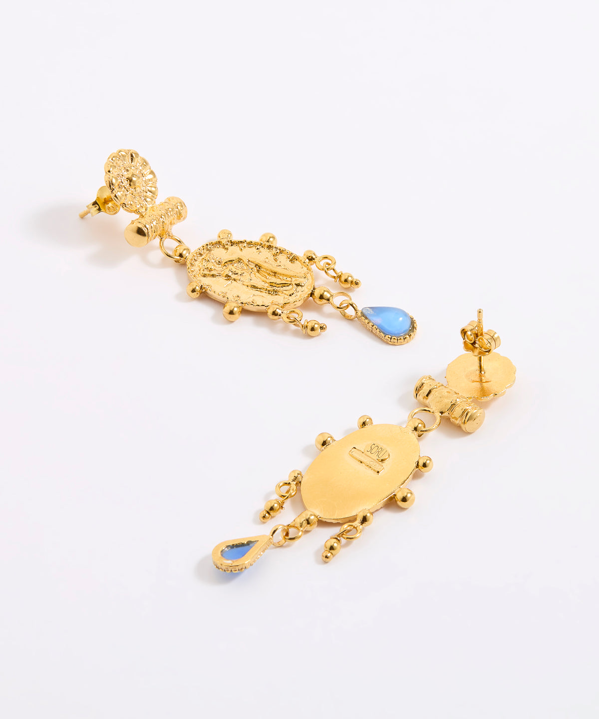 Reverse and front image of a pair of earrings, feature Oval, organically finished medallion featuring the figure of a woman. Handmade with classic detailing and a decorative border, finished with a delicate pale blue hanging glass cabochon.