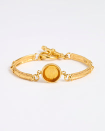 Gold link bracelet with round pendant in the centre with amber  glass