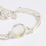 Silver link bracelet with round pendant in the centre with clear glass and embossed image of twins and inscription 'you are loved'