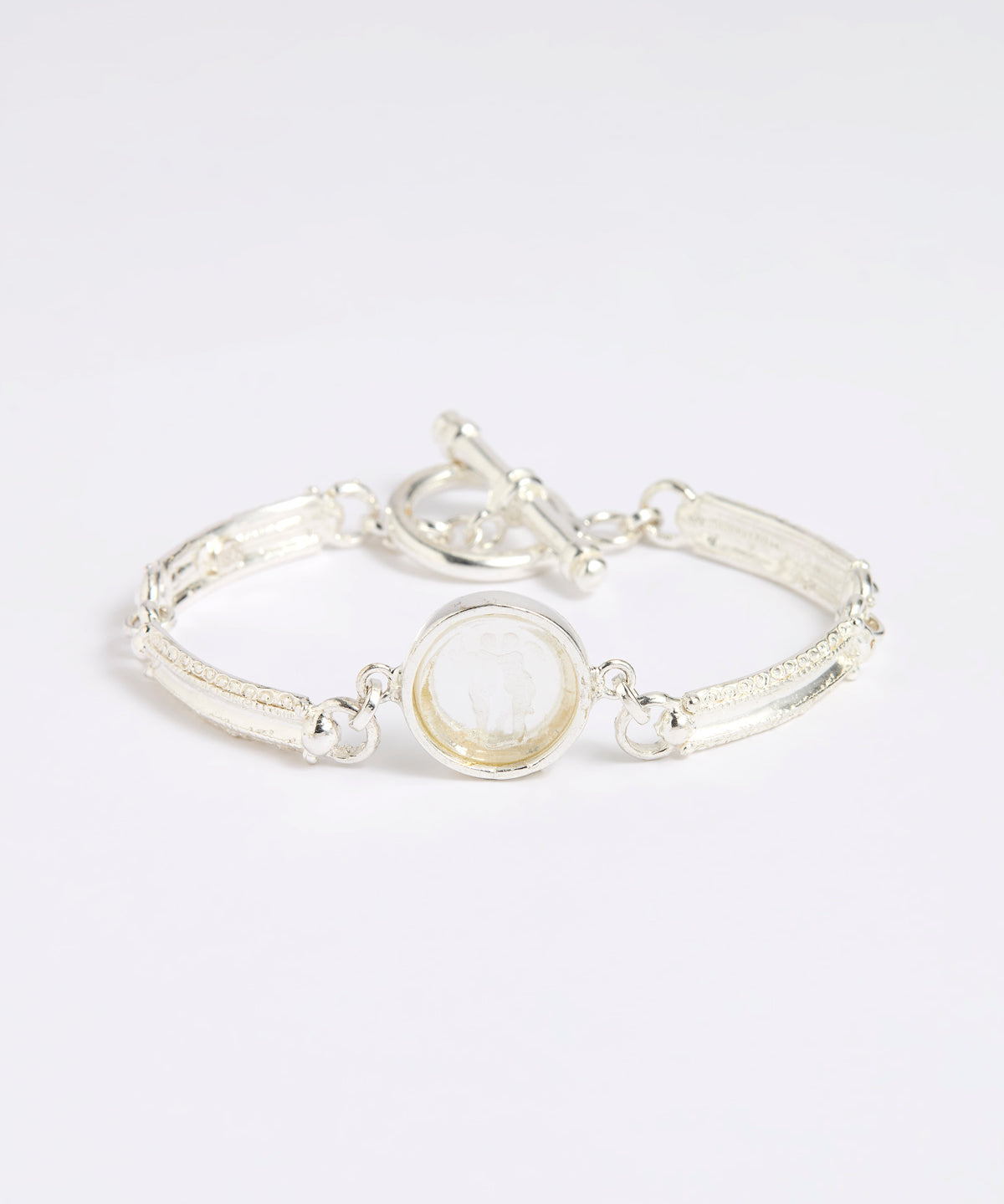 Silver link bracelet with round pendant in the centre with clear glass and embossed image of twins.