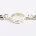 Silver link bracelet with round pendant in the centre with clear glass and embossed image of twins and inscription 'you are loved'