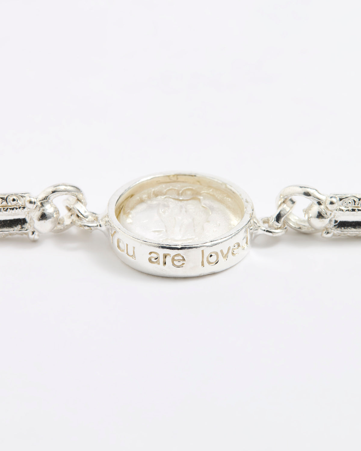 Silver link bracelet with round pendant in the centre with clear glass and embossed image of twins and inscription 'you are loved'