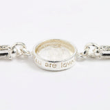 Silver link bracelet with round pendant in the centre with clear glass and embossed image of twins and inscription 'you are loved'