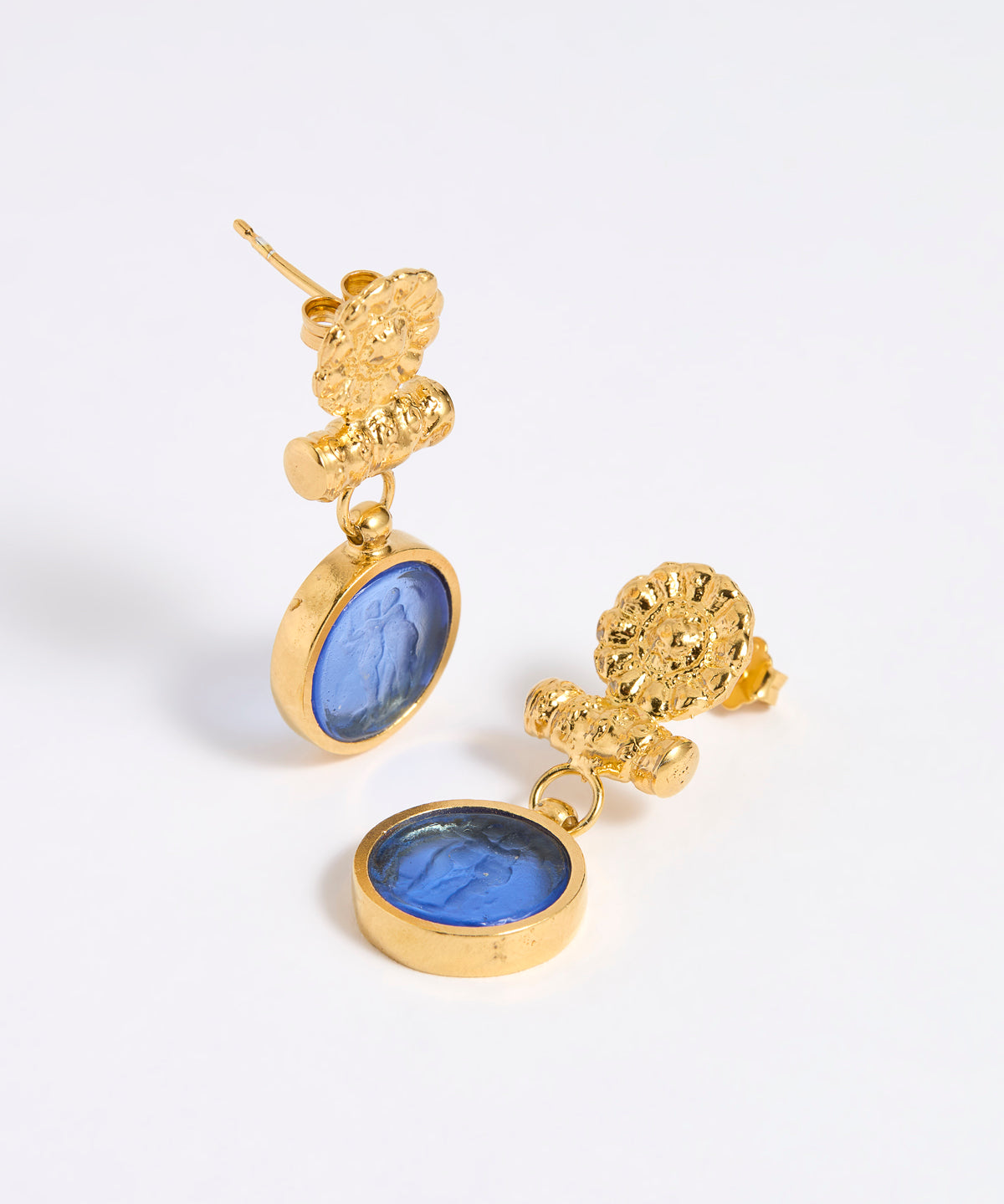 Gold coloured earrings with blue glass centre