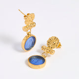 Gold coloured earrings with blue glass centre
