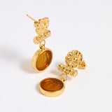Gold plated  drop earrings with round amber glass pendant featuring an image of twins.