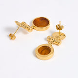 Reverse image of Gold plated  drop earrings with round amber glass pendant featuring an image of twins.