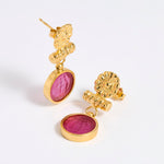 Gold plated  drop earrings with round magenta glass pendant featuring an image of twins.