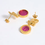 Reverse image of Gold plated  drop earrings with round amber glass pendant featuring an image of twins.