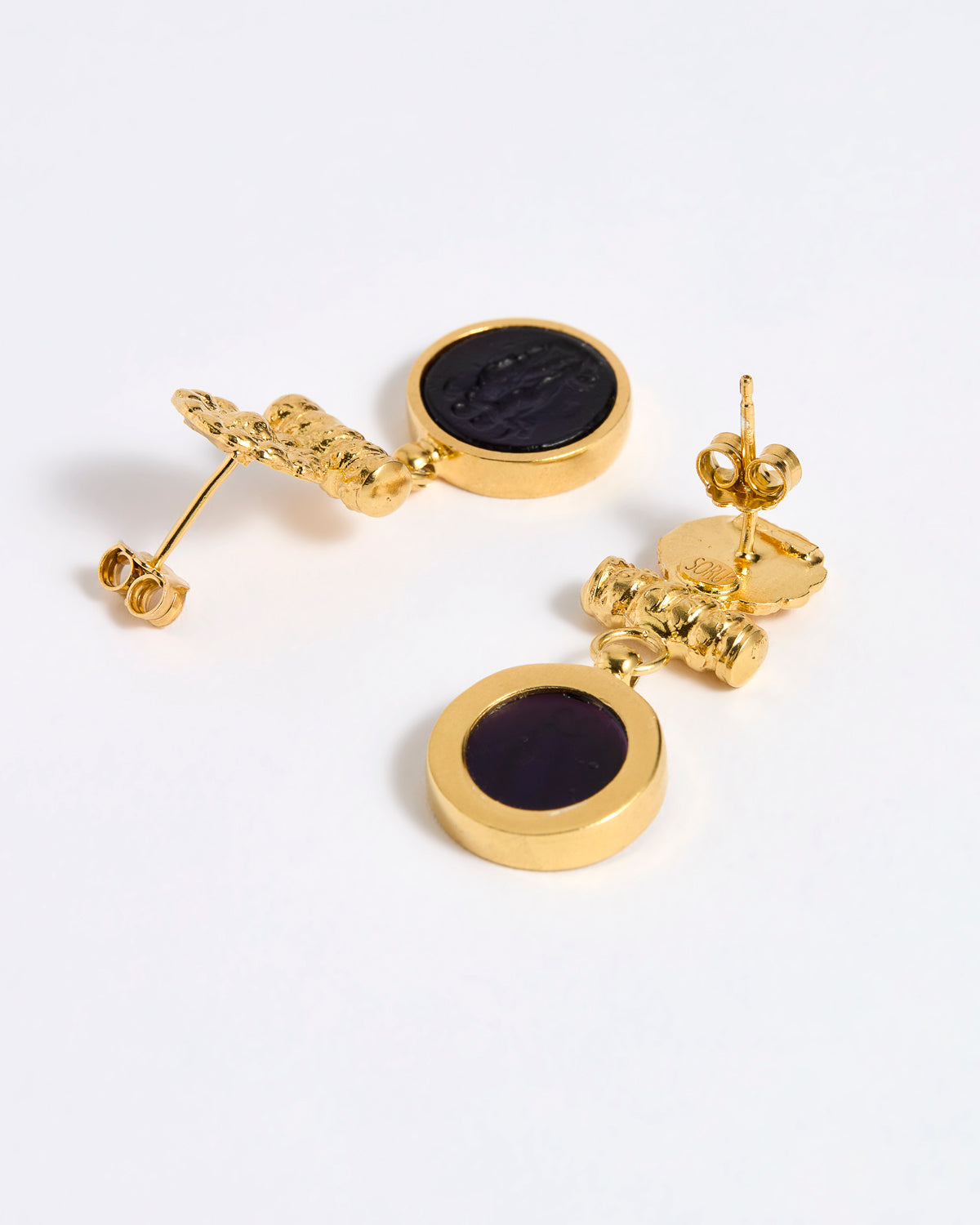 Reverse image of Gold plated  drop earrings with round violet glass pendant featuring an image of twins.