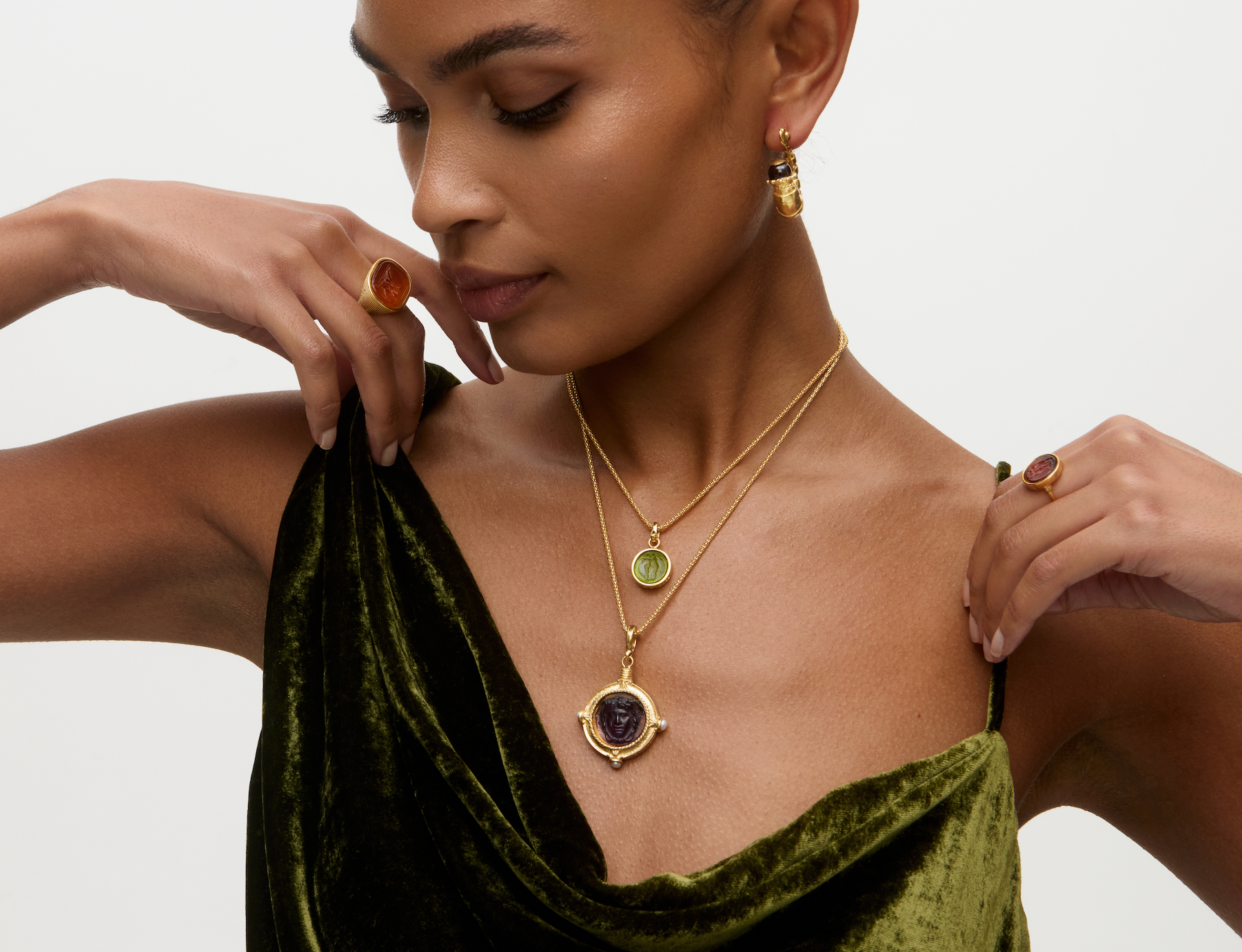 Model wearing layered necklaces featuring murano glass pendants and matching rings.