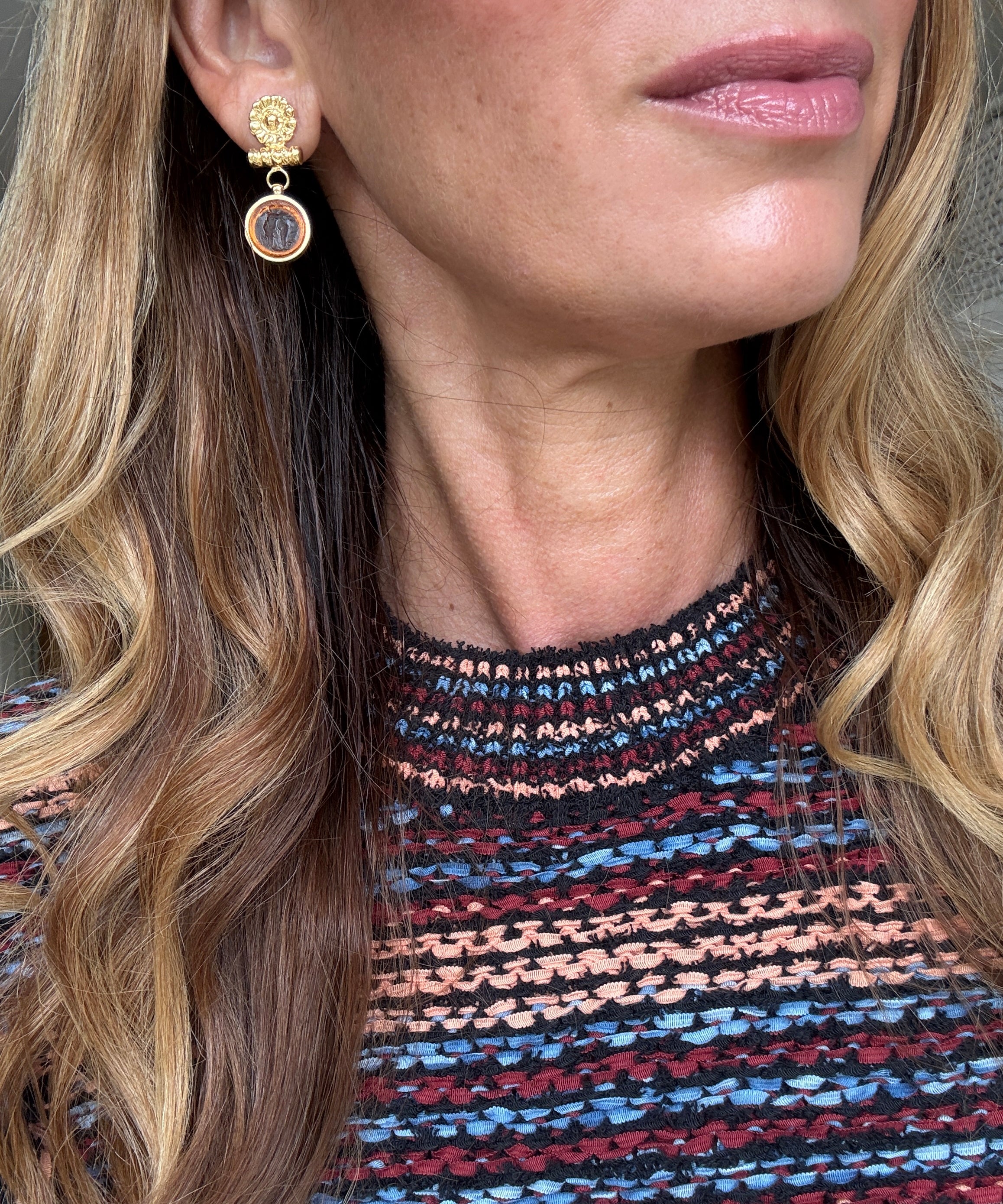 small round glass mythos earrings shown on ear