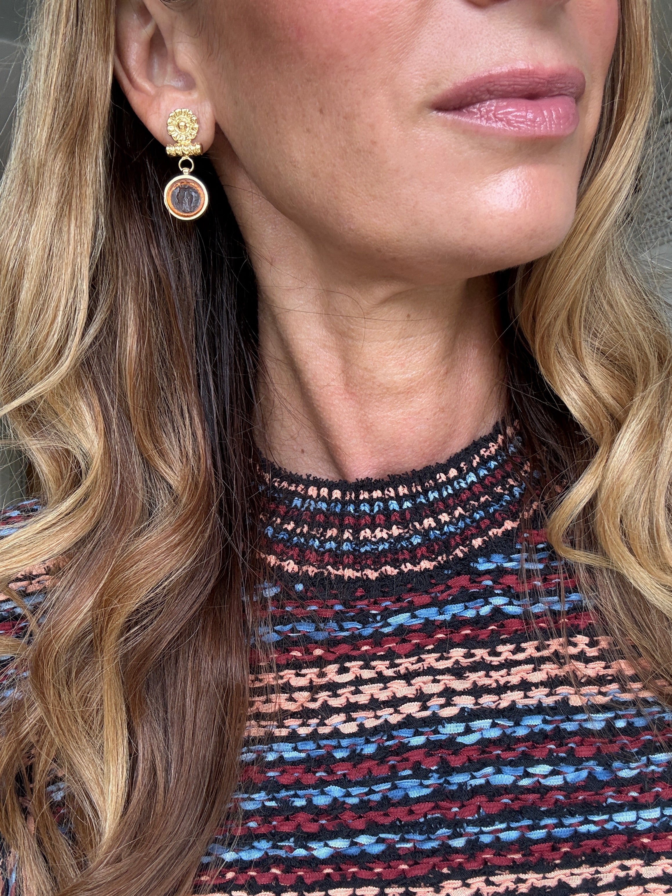 small round glass mythos earrings shown on ear