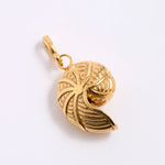 Gold coloured shell shaped pendant on a white background