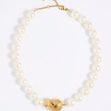 Pearl necklace with statement shell pendant  on a white background