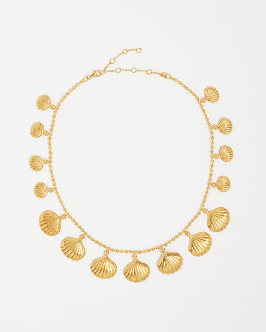 product shot of yellow gold plated necklace with shells attached around the necklace