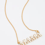gold and white enamel mama letter necklace with clear crystal detailing, close up image.