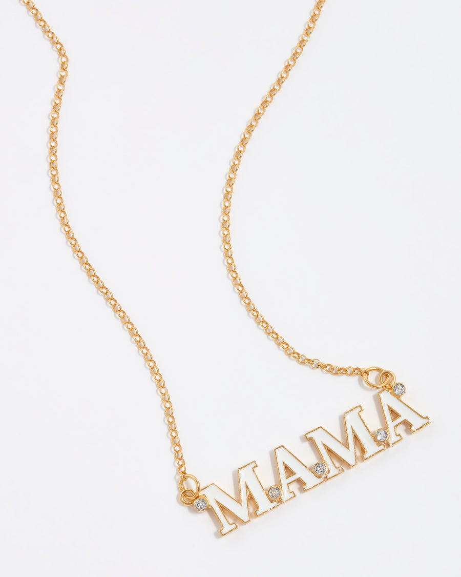 gold and white enamel mama letter necklace with clear crystal detailing, close up image.